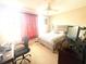 Well-lit bedroom with desk, neutral walls, and cozy carpet for a functional and comfortable space at 3128 Bayshore Oaks Dr, Tampa, FL 33611