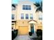 Charming townhouse with a one-car garage and a welcoming teal-colored front door at 3128 Bayshore Oaks Dr, Tampa, FL 33611