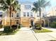 Charming two-story townhome with well-manicured landscaping and two palm trees for added curb appeal at 3128 Bayshore Oaks Dr, Tampa, FL 33611