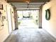 Attached one car garage showing an opened garage door with access to the driveway and street at 3128 Bayshore Oaks Dr, Tampa, FL 33611