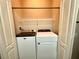 Efficient laundry room with modern Maytag washer and Whirlpool dryer for convenient home chores at 3128 Bayshore Oaks Dr, Tampa, FL 33611