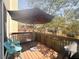 Cozy patio area with seating, umbrella, and wood railing offering a relaxing outdoor space at 3128 Bayshore Oaks Dr, Tampa, FL 33611