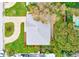 Aerial shot showcasing the house's roof, driveway, surrounding greenery, and neighborhood at 316 Barbara Cir, Belleair, FL 33756