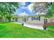 Spacious backyard featuring a brick paver patio and blue flower pots at 316 Barbara Cir, Belleair, FL 33756