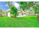 Spacious backyard offering a patio area, privacy fence, and a well-kept lawn, perfect for outdoor enjoyment at 316 Barbara Cir, Belleair, FL 33756