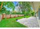 Spacious backyard featuring a brick paver patio and a well-maintained lawn at 316 Barbara Cir, Belleair, FL 33756