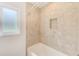 Tile surround shower and tub combo featuring a built-in shampoo niche at 316 Barbara Cir, Belleair, FL 33756