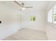 Clean bedroom with a ceiling fan, light walls, and light wood-look flooring at 316 Barbara Cir, Belleair, FL 33756