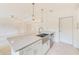 Spacious kitchen island with granite countertops, stainless sink, and stainless steel dishwasher at 316 Barbara Cir, Belleair, FL 33756