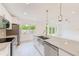 Bright, airy kitchen with stainless appliances, granite countertops, and view of backyard at 316 Barbara Cir, Belleair, FL 33756