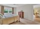 Bedroom with a large window, hardwood floors, neutral color palette, and natural light at 3401 Stonehaven E Ct # A, Palm Harbor, FL 34684