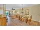 Open concept dining area and living room with chandelier lighting and hardwood floors at 3401 Stonehaven E Ct # A, Palm Harbor, FL 34684