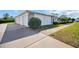 Exterior view showcasing the attached garage and well-manicured lawn at 3401 Stonehaven E Ct # A, Palm Harbor, FL 34684