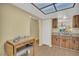 Kitchen area featuring wooden cabinets, a sink overlooking the outdoors, and laminate flooring at 3401 Stonehaven E Ct # A, Palm Harbor, FL 34684