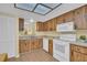 Classic kitchen featuring wood cabinets, modern appliances, and a view of the sink at 3401 Stonehaven E Ct # A, Palm Harbor, FL 34684