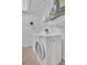 Functional laundry area equipped with a washing machine, dryer, and wire shelving for storage at 3401 Stonehaven E Ct # A, Palm Harbor, FL 34684