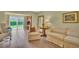 Living room with neutral colors and a sliding glass door to the outside at 3401 Stonehaven E Ct # A, Palm Harbor, FL 34684