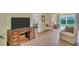 Spacious living room with wood floors, comfortable seating, and views of the outdoors at 3401 Stonehaven E Ct # A, Palm Harbor, FL 34684