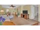 Inviting living space with comfortable seating, a decorative plant, and a clear view of the dining area at 3401 Stonehaven E Ct # A, Palm Harbor, FL 34684