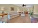 Open living space with a cozy sofa, chairs, and a view into the dining area at 3401 Stonehaven E Ct # A, Palm Harbor, FL 34684