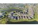 Overhead shot showcasing homes in a lakeside community with manicured lawns and a roundabout for easy access at 34303 Radley Way, Wesley Chapel, FL 33545