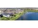 Beautiful aerial view of homes alongside a lake, showcasing the community's serene and picturesque setting at 34303 Radley Way, Wesley Chapel, FL 33545