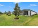 Wide-open backyard with tree and pond views at 34303 Radley Way, Wesley Chapel, FL 33545