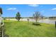 Expansive backyard with a serene pond view and well-maintained lawn at 34303 Radley Way, Wesley Chapel, FL 33545