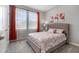 Bedroom featuring orange curtains, carpet floors, and a upholstered headboard on the bed at 34303 Radley Way, Wesley Chapel, FL 33545