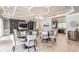 Elegant clubhouse with stylish seating areas, a TV, kitchen, and decorative lighting at 34303 Radley Way, Wesley Chapel, FL 33545