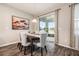 Elegant dining room featuring a modern light fixture, large sliding glass door, and stylish decor at 34303 Radley Way, Wesley Chapel, FL 33545