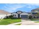 Charming single-Gathering home with a well-manicured lawn and a two-car garage, nestled in a friendly neighborhood at 34303 Radley Way, Wesley Chapel, FL 33545
