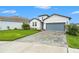 Beautiful single-Gathering home featuring a manicured lawn and a stylish two-car garage at 34303 Radley Way, Wesley Chapel, FL 33545