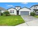 Beautiful single-Gathering home featuring a manicured lawn and a stylish two-car garage at 34303 Radley Way, Wesley Chapel, FL 33545