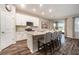 Modern kitchen with stainless steel appliances, granite countertops, and a breakfast bar at 34303 Radley Way, Wesley Chapel, FL 33545