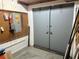 Basement with large doors and pegboard walls at 35118 Whispering Oaks Blvd, Dade City, FL 33523