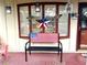 Inviting front porch decorated with patriotic decor and charming accents at 35118 Whispering Oaks Blvd, Dade City, FL 33523