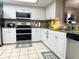 Bright kitchen featuring white cabinets, granite countertops, stainless appliances, and tile flooring at 35118 Whispering Oaks Blvd, Dade City, FL 33523