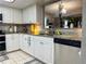 Charming kitchen featuring white cabinets, granite countertops, and modern stainless steel appliances at 35118 Whispering Oaks Blvd, Dade City, FL 33523