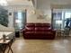 A well-lit living room boasts a stylish sofa, attractive wall decorations, and sleek flooring at 35118 Whispering Oaks Blvd, Dade City, FL 33523