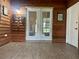 Spacious living area features a wood accent wall and glass doors leading to the backyard at 35118 Whispering Oaks Blvd, Dade City, FL 33523