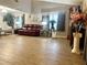 Bright and spacious living room features hardwood floors, a leather sofa, and neutral wall colors at 35118 Whispering Oaks Blvd, Dade City, FL 33523