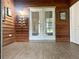 Spacious living area features a wood accent wall and glass doors leading to the backyard at 35118 Whispering Oaks Blvd, Dade City, FL 33523