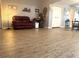 An open floor plan showcases wood-look flooring, a leather sofa, and decorative accents at 35118 Whispering Oaks Blvd, Dade City, FL 33523