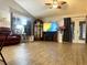 Spacious living room featuring vaulted ceilings, ample natural light, and a decorative grandfather clock at 35118 Whispering Oaks Blvd, Dade City, FL 33523