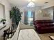 Bright living room with a modern sofa, accent tables, and neutral wall decor at 35118 Whispering Oaks Blvd, Dade City, FL 33523