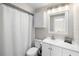 Bright bathroom features a white vanity, toilet, and shower with curtain at 3515 Centavo Ct, Hernando Beach, FL 34607