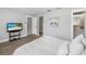 Bedroom with wood floors and a television near the bathroom door at 3515 Centavo Ct, Hernando Beach, FL 34607