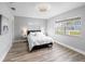 Bright bedroom features wood floors, a large window, and neutral decor at 3515 Centavo Ct, Hernando Beach, FL 34607