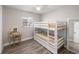 Bedroom with bunk beds, a desk, wood floors, and natural lighting at 3515 Centavo Ct, Hernando Beach, FL 34607